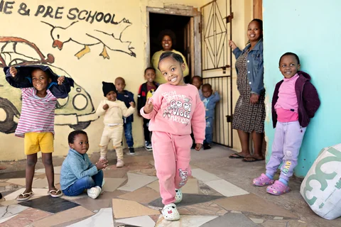 Child walking showing peace sign